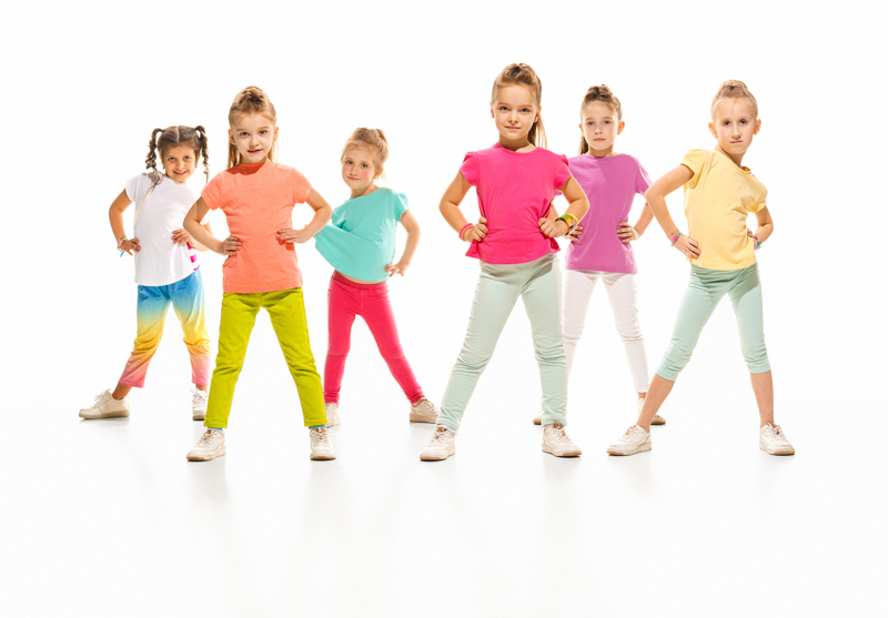 The kids dance school, ballet, hiphop, street, funky and modern dancers on white studio background. Girl is showing aerobic and dance element. Teen in hip hop style
